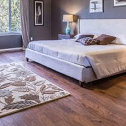 how to position an area rug in a bedroom